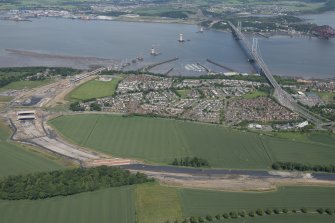 Oblique aerial view of the construction of the new Queensferry Crossing, the Forth Road Bridge and South Queensferry, looking NNW.