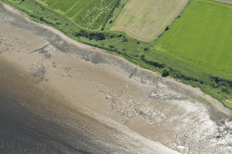 Oblique aerial view of the remains of the fish trap, looking SE.