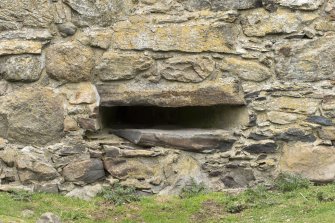 Invermark Castle. Basement, detail of horizontal slit window opening at west end of south face
