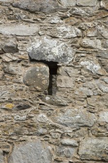 Invermark Castle. Detail of small slit window on west face at 1st floor level