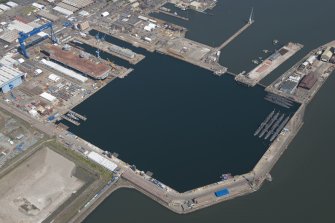Oblique aerial view of the submarines in the main basin of Rosyth Dockyard, looking ENE.
