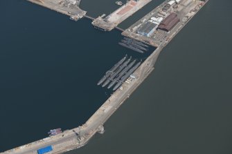 Oblique aerial view of the submarines in the main basin of Rosyth Dockyard, looking NE.