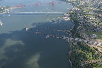 Oblique aerial view of the construction of the Queensferry Crossing and Port Edgar, looking E.