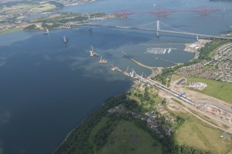 Oblique aerial view of the construction of the Queensferry Crossing and Port Edgar, looking E.