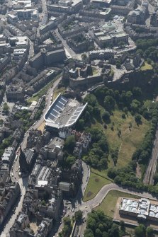 Oblique aerial view of Edinburgh Castle and Esplanade, looking SW.