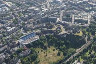 Oblique aerial view of Edinburgh Castle and Esplanade, looking S.