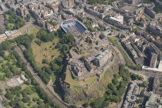 Oblique aerial view of Edinburgh Castle and Esplanade, looking ESE.
