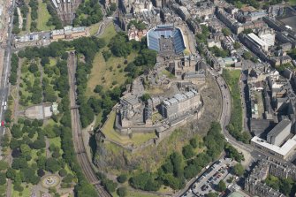 Oblique aerial view of Edinburgh Castle and Esplanade, looking E.