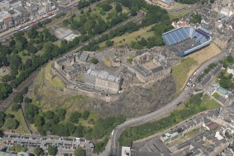 Oblique aerial view of Edinburgh Castle and Esplanade, looking NNE.