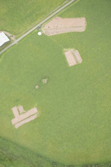 Oblique aerial view of the Glasgow University excavations with Wellhill farmstead adjacent, looking ENE.