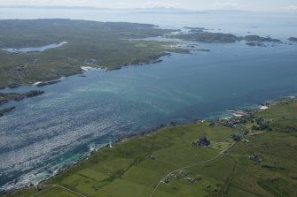 General oblique aerial view of Iona and Mull with the Paps of Jura in the distance, looking SE.