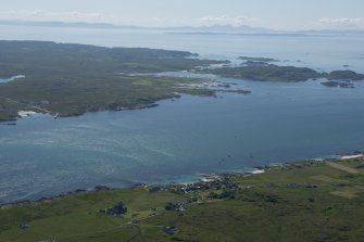 General oblique aerial view of Iona and Mull with the Paps of Jura in the distance, looking SE.