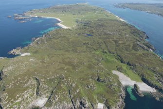 General oblique aerial view of Iona with Port na Curaich in the foreground, looking NNE.