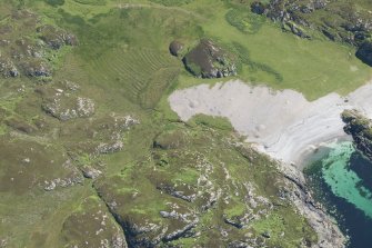 Oblique aerial view of Port na Curaich, Iona, looking SE.