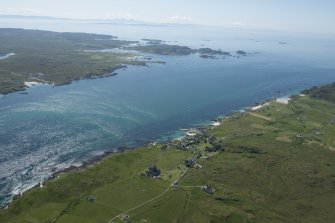 General oblique aerial view of Iona and Mull with the Paps of Jura in the distance, looking SE.