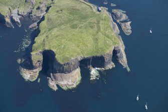 Oblique aerial view of Staffa centred on Fingal's Cave, looking NE.