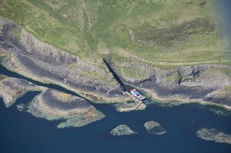 Oblique aerial view of Clamshell Cave and the jetty, Staffa, looking NNW.