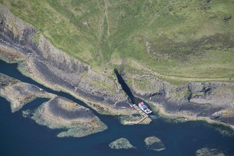 Oblique aerial view of Clamshell Cave and the jetty, Staffa, looking NNW.