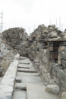 Lower parapet level, north side, view from east showing stone slabs interleaved over wall head
