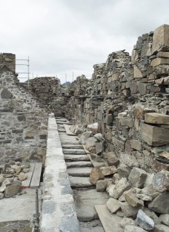 Lower parapet level, north side, general view from east showing stone slabs interleaved over wall head