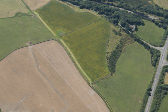 Oblique aerial view of the cropmarks of the ditch of the Roman Temporary Camp, looking SW.