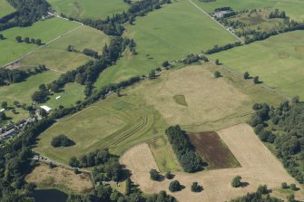 Oblique aerial view of Ardoch Roman fort, looking NW.