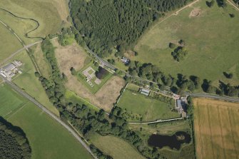 Oblique aerial view of Deer Abbey and walled garden, looking NW.