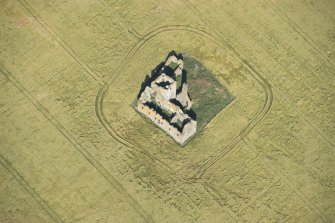 Oblique aerial view of Castle of Pittulie, looking NW.