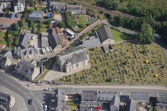 Oblique aerial view of Kintore Parish Church and churchyard, looking NNE.