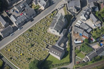 Oblique aerial view of Kintore Parish Church and churchyard, looking WSW.