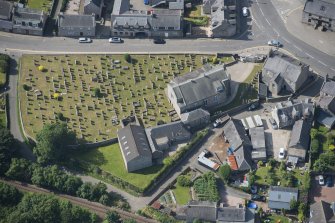 Oblique aerial view of Kintore Parish Church and churchyard, looking SW.