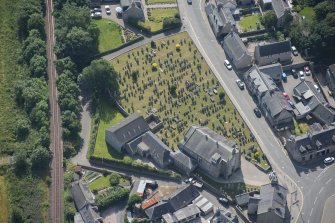 Oblique aerial view of Kintore Parish Church and churchyard, looking SSE.