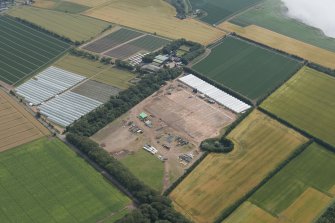 General oblique aerial view of the polytunnels at Windyhills, looking W.