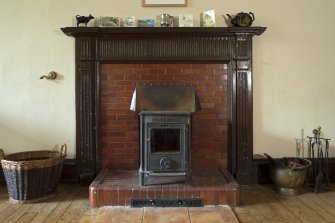 Ground floor, living room / kitchen, detail of fireplace with stove