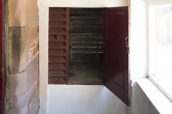 Detail of game larder (door open) in north east wing porch.