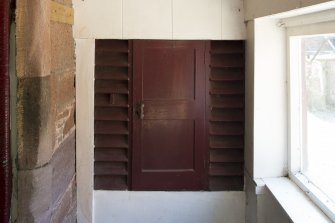 Detail of game larder (door closed) in north east wing porch.