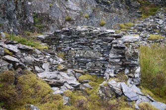 View of outbuilding of drystone slate construction from south