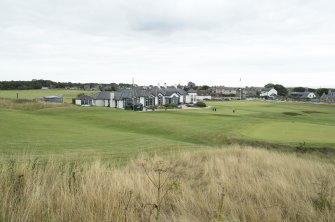 Clubhouse and 1st fairway tee box from west.