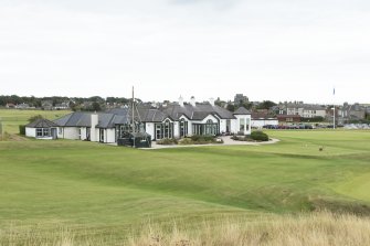 Clubhouse and 1st fairway tee box from west.