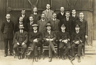 Photograph of various dock workers and Navy personnel.