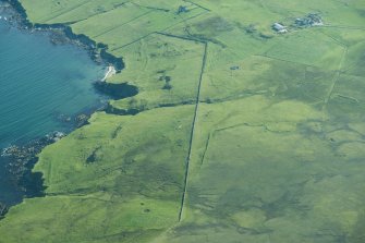 Oblique aerial view of Kirkhouse, Fetlar, looking NE.