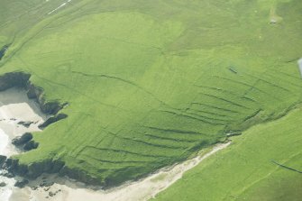 Oblique aerial view of Inner Skaw and The Garths, Unst, looking SE.