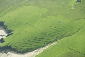 Oblique aerial view of Inner Skaw and The Garths, Unst, looking SE.