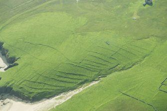 Oblique aerial view of Inner Skaw and The Garths, Unst, looking SE.