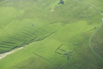 Oblique aerial view of Inner Skaw and The Garths, Unst, looking SE.