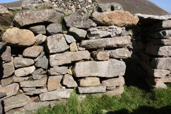 Blackhouse V, blocked window opening and areas of rebuilding in the ENE wall.