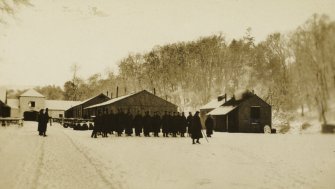 View of soldiers on parade at Stobs Camp by the castle steading.
