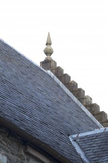 Detail of stone finial on north gable of east elevation