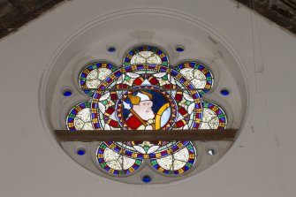 Interior. Detail of stained glass window at east end of main hall