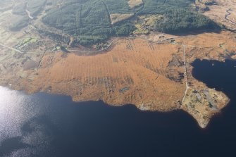 Oblique aerial view of the partially constructed Loch Doon airfield, showing the complex arrangement of field drains used to drain the peaty ground and site of the hangers, looking SW.